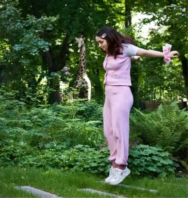 Alice jumping in the garden